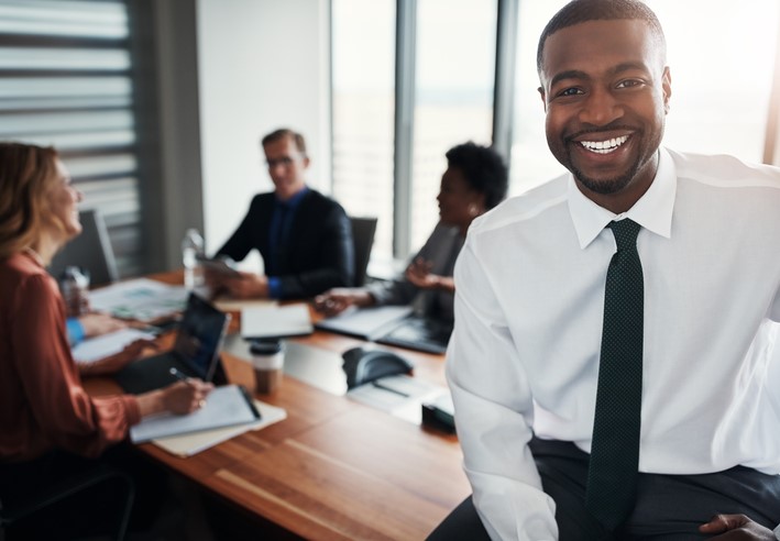Man smiling in a team meeting