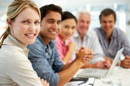 Smiling multicultural team meeting around a table